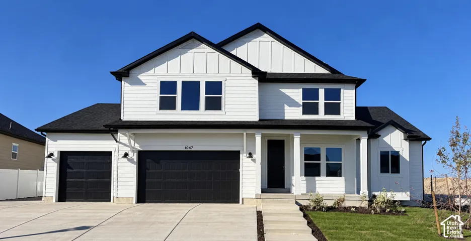 Modern farmhouse exterior with white siding and black trim accents