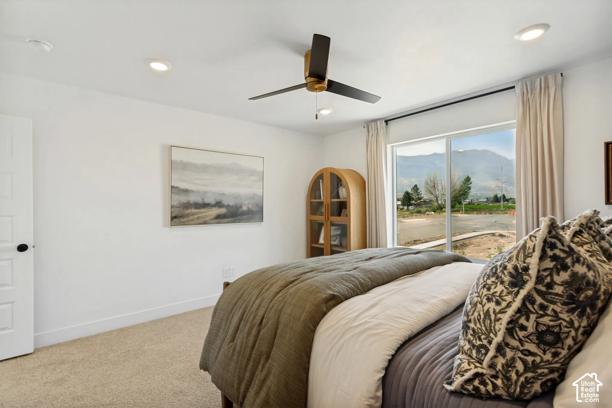 Recessed lighting, ceiling fan, carpeted flooring, sliding glass door, and white paneled door