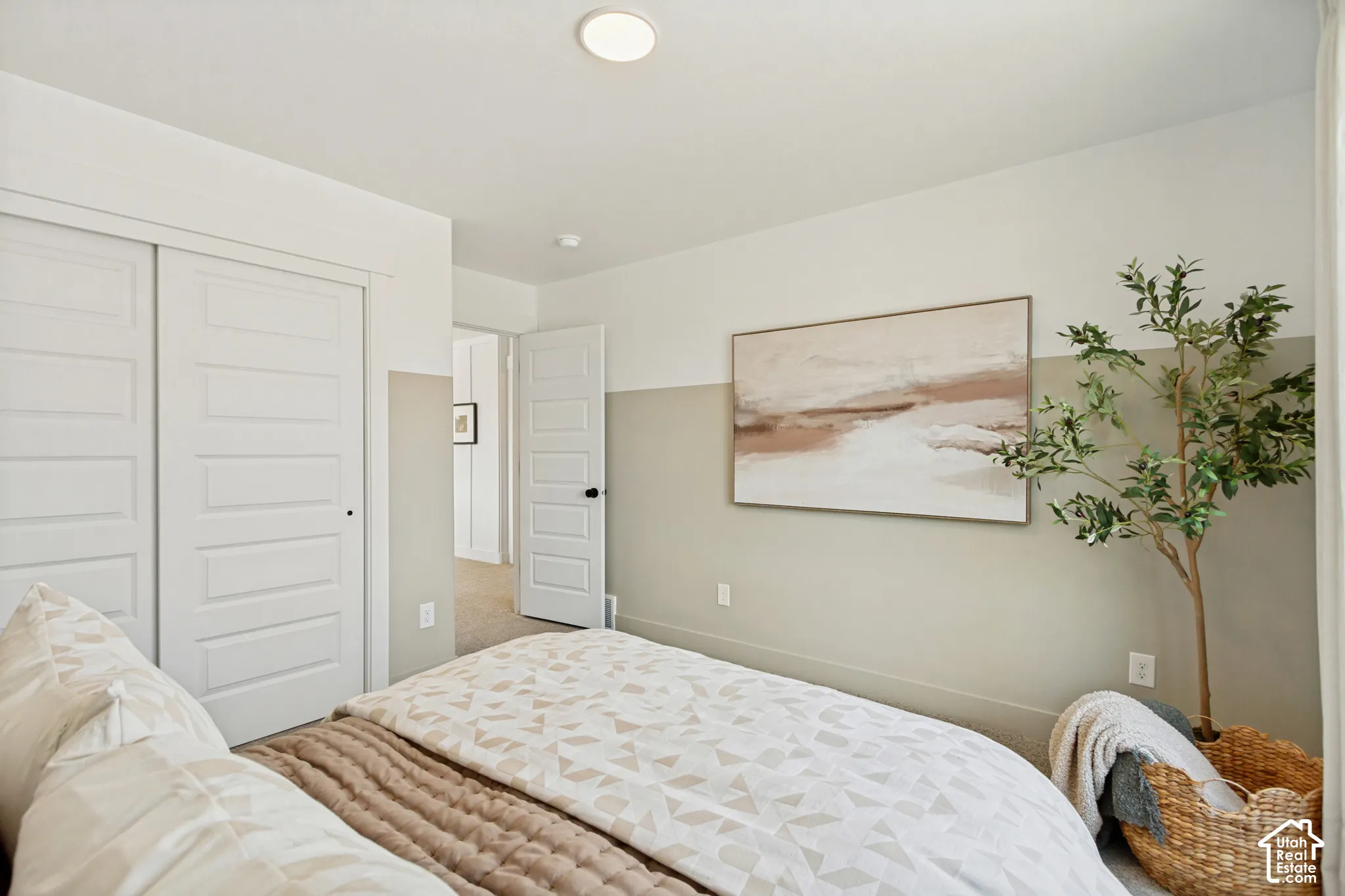 White sliding closet doors, five-panel interior door, recessed ceiling light, two-tone wall paint, and wood-finish flooring