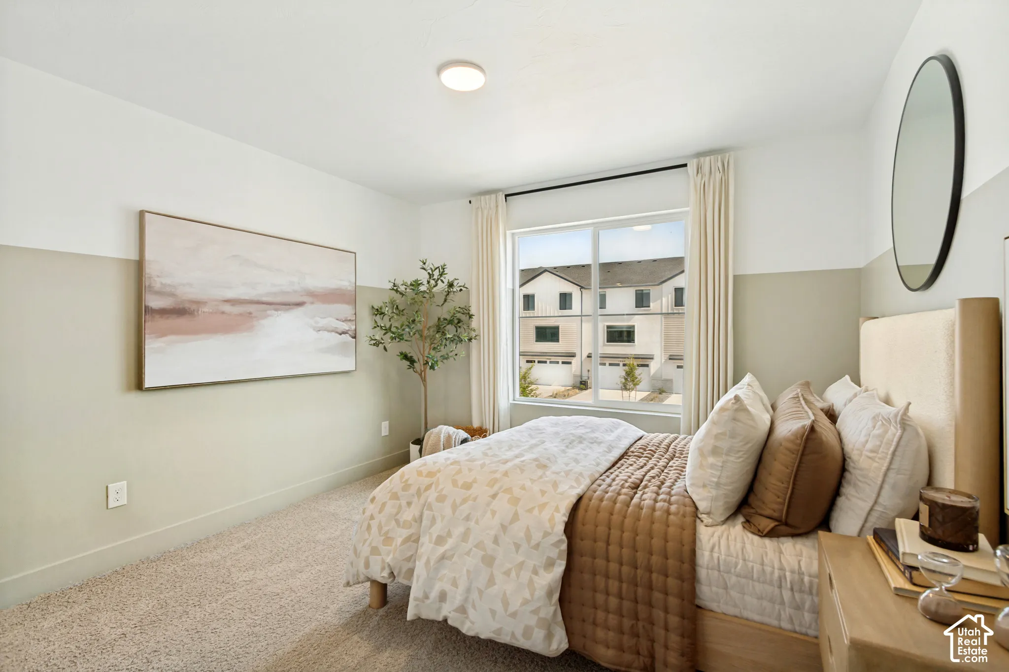 Expansive window with roller shade capability, two-tone wall finish, and carpeted flooring