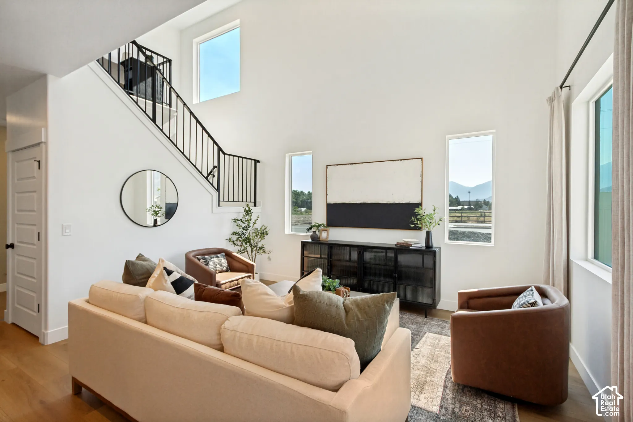 Expansive living area featuring soaring ceilings and abundant natural light