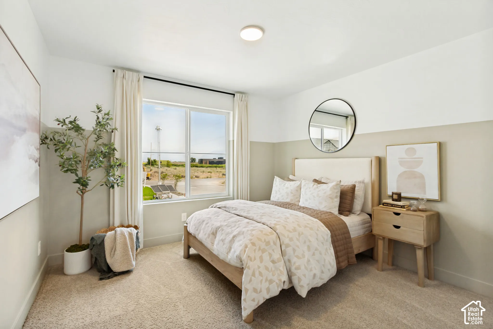 Recessed ceiling light, carpet flooring, two-tone wall paint, and a large window with roller shades