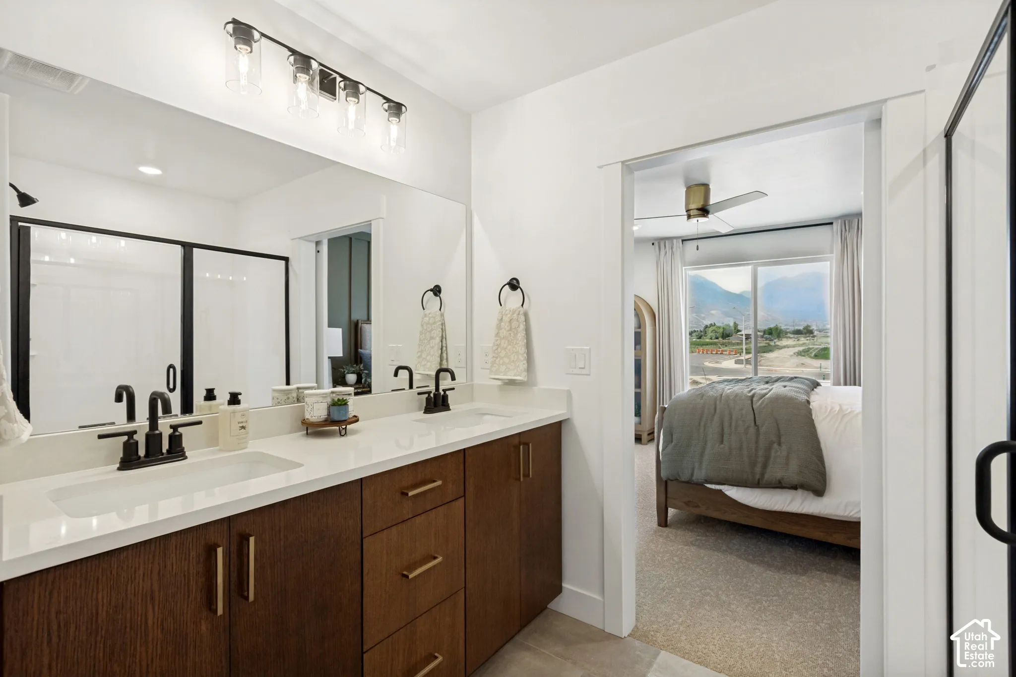Dual vanity with undermount sinks, quartz countertop, and dark wood-finish cabinetry
