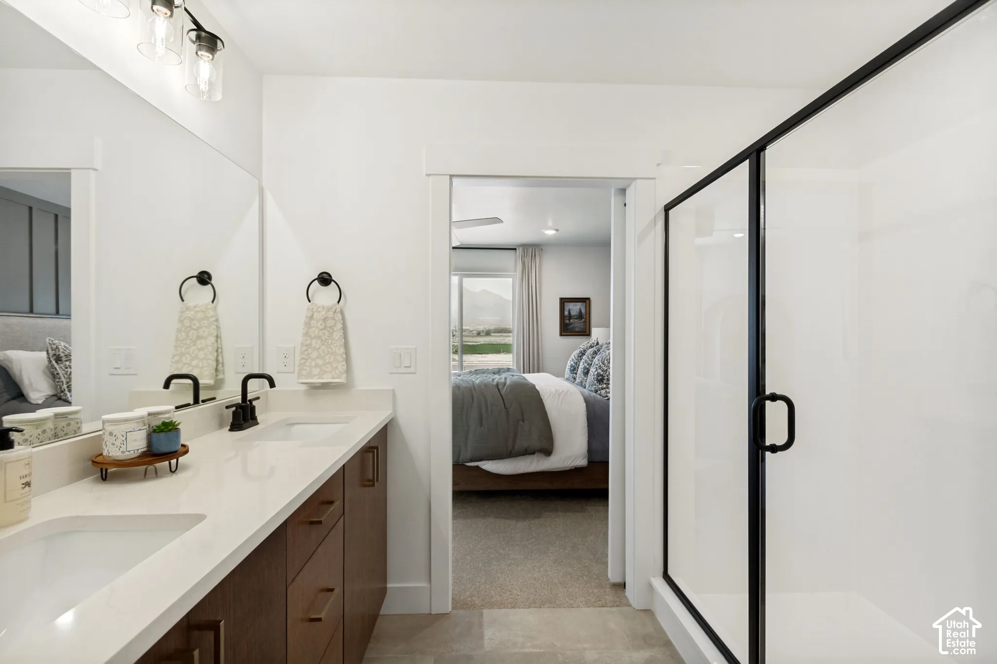 Dual vanity with rectangular undermount sinks, matte black faucets, and wood-finish cabinetry