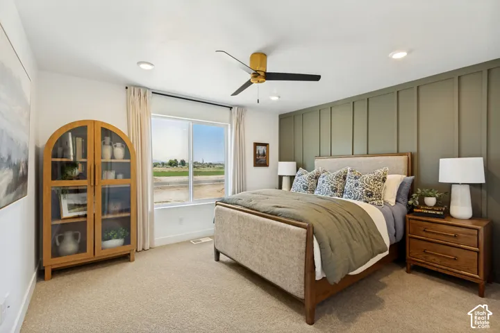 Board and batten accent wall, recessed lighting, ceiling fan, and carpeted flooring