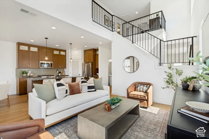 Open-concept living space with high ceilings and wood-finish flooring
