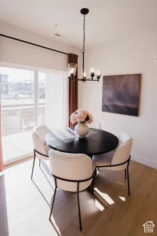 Wood-finish flooring with a modern black chandelier