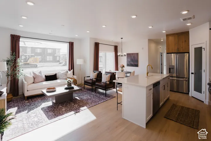Open-concept living space featuring wood-finish flooring and recessed lighting