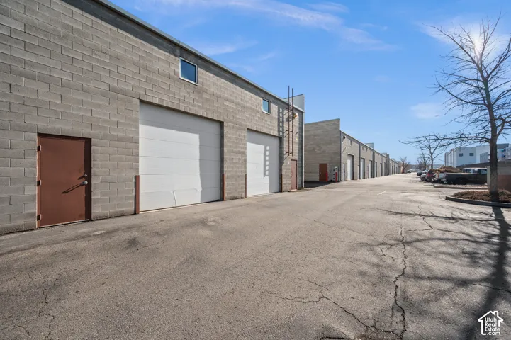 Concrete block exterior with multiple bay doors and individual entry doors