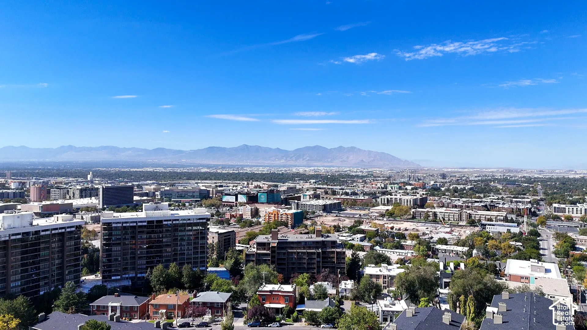 Expansive urban landscape with distant mountains under a clear sky
