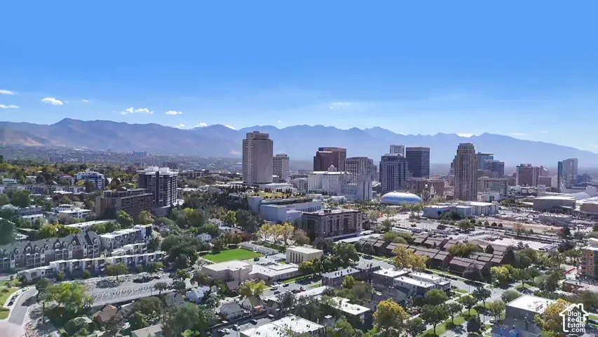 Expansive cityscape featuring a collection of high-rise buildings, a domed structure, and numerous commercial properties