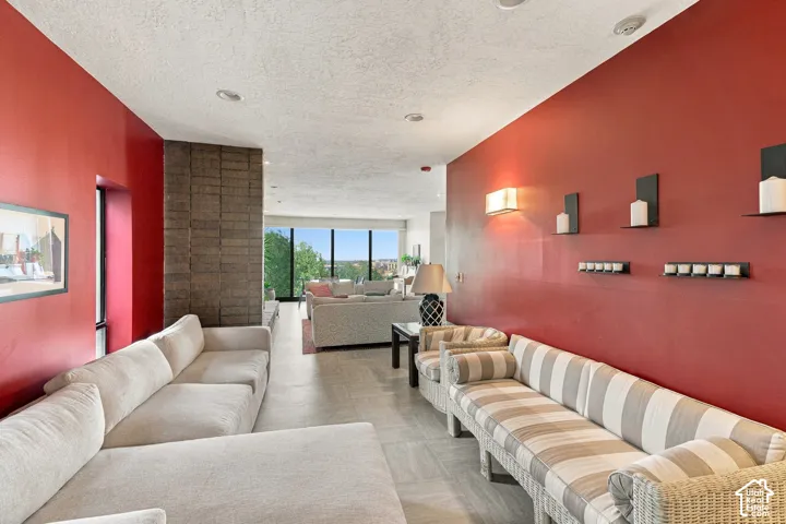 Recessed lighting and a textured ceiling complement the red accent wall