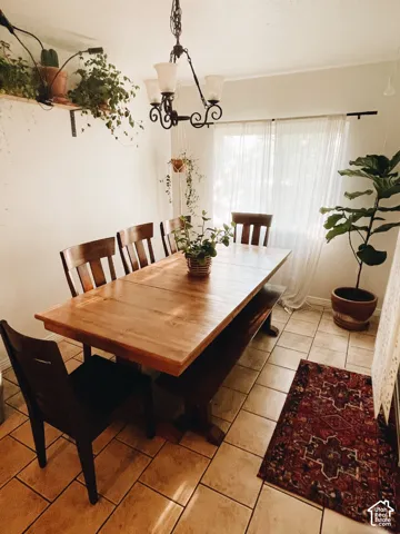 Recessed lighting, tiled flooring, and a decorative chandelier