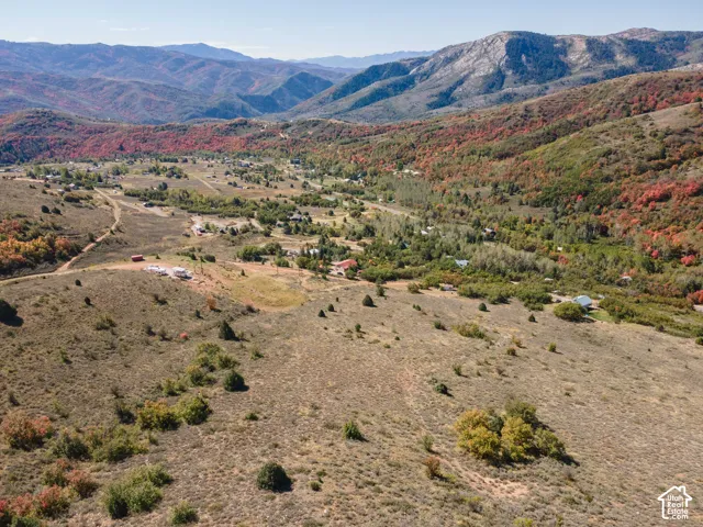 Expansive mountain terrain with visible building sites and established structures