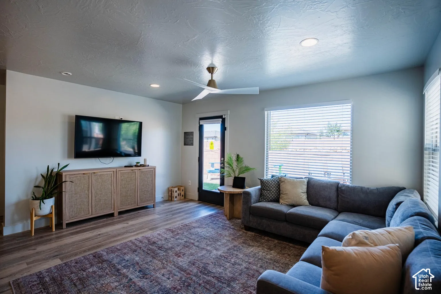 Wood-finish flooring, recessed lighting, and a ceiling fan