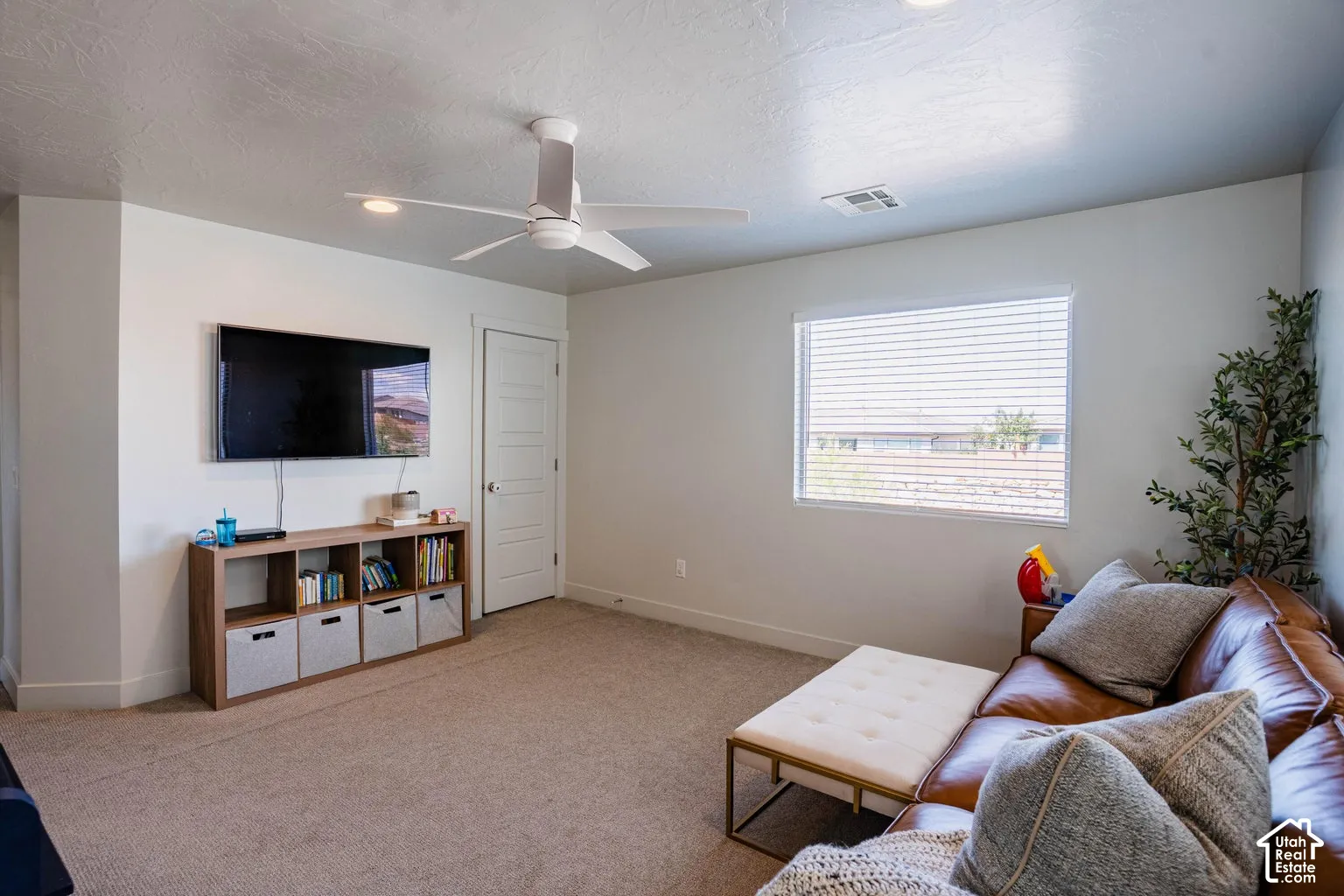 Neutral wall finishes, recessed lighting, and a ceiling fan with integrated lighting