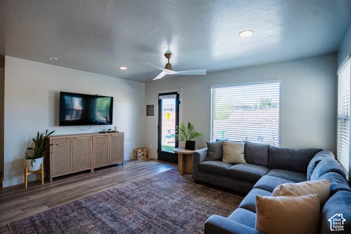 Wood-finish flooring, recessed lighting, and a ceiling fan