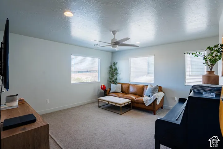 Recessed lighting, ceiling fan, and multiple windows with blinds