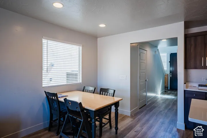 Wood-finish flooring, recessed ceiling lights, and white wall finishes