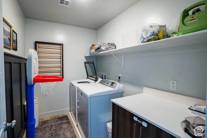 Built-in shelving, wood-finish flooring, and a countertop with cabinetry