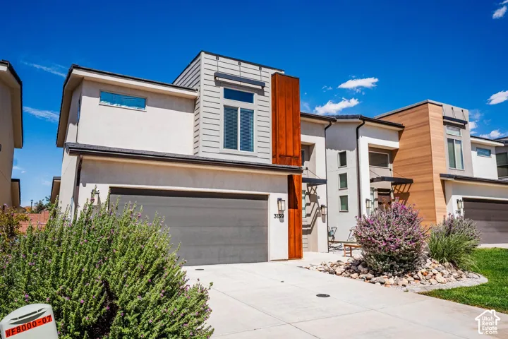 Modern architectural design featuring varied facade materials and a covered entry