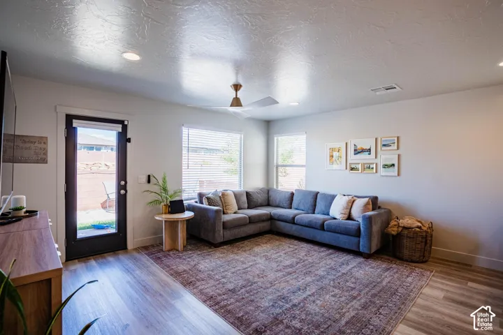 Wood-finish flooring, recessed lighting, and a modern ceiling fan