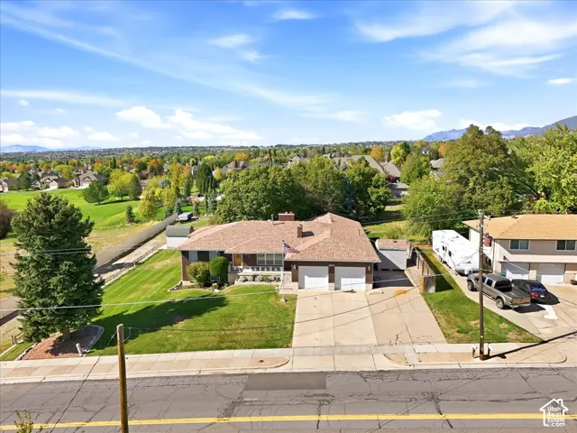 Single-story residence featuring a two-car garage, concrete driveway, and a front lawn