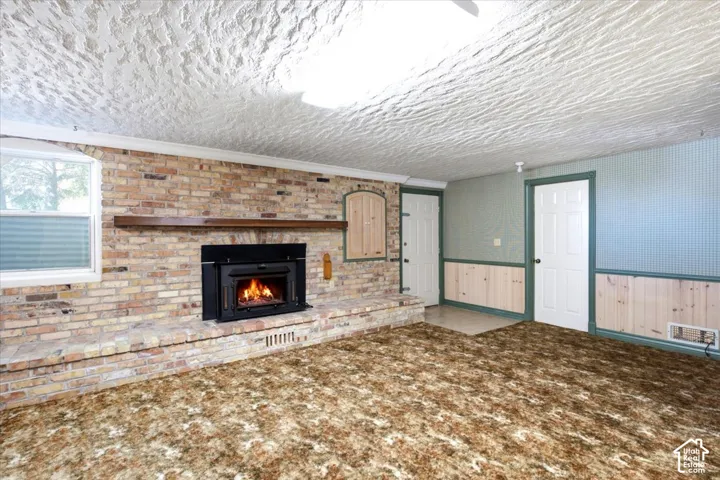 Brick fireplace with a wood mantel