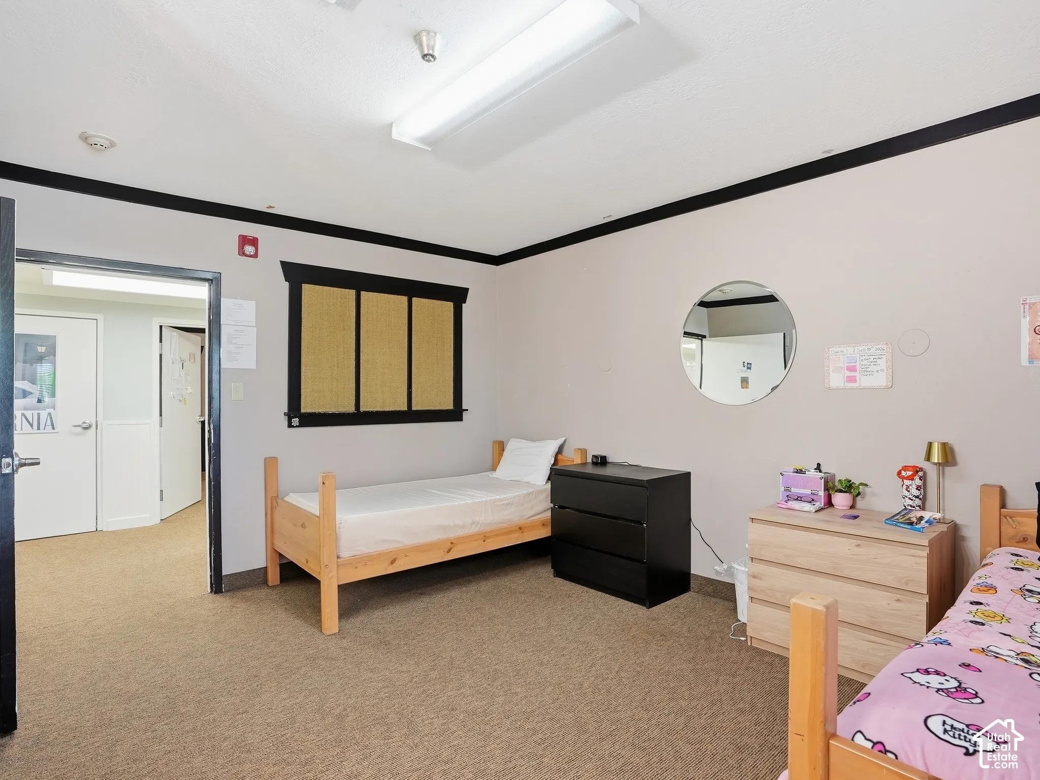 Carpeted flooring throughout with recessed lighting and a window featuring horizontal blinds