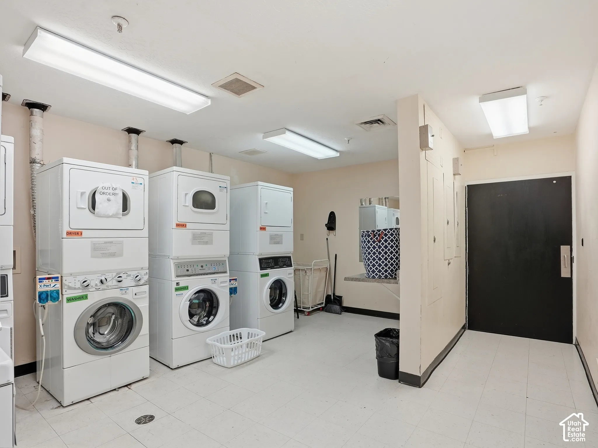 Dedicated laundry facility with multiple stacked washer and dryer units