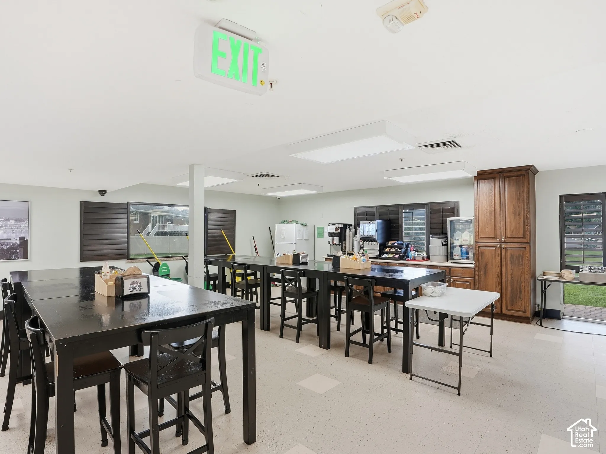 Spacious communal room featuring extensive counter space, built-in cabinetry, and tile flooring