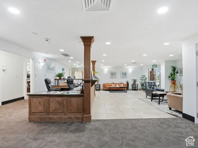 Reception area featuring a wood-panel desk with stone-finish countertop