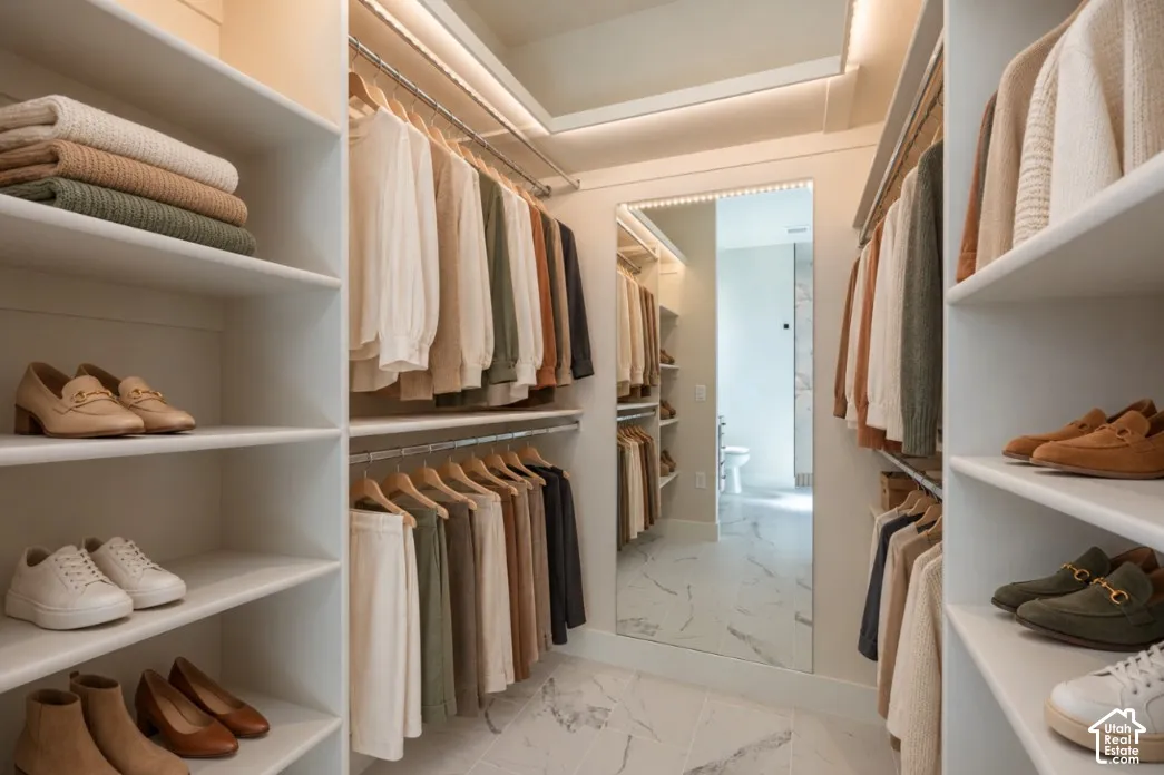 Custom closet system featuring built-in shelving, hanging rods, and integrated lighting