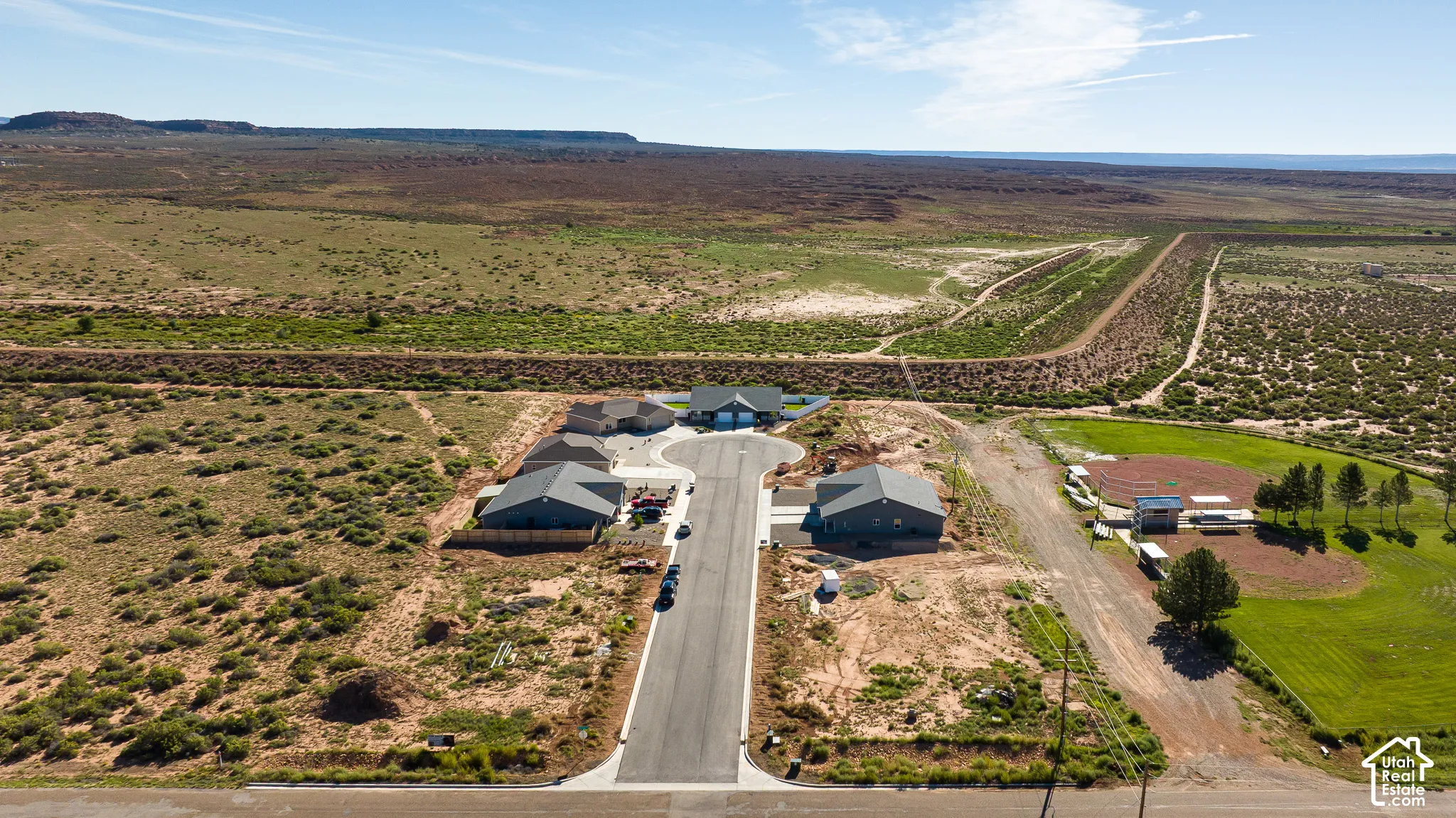 Cul-de-sac development featuring multiple single-story residences with prominent natural surroundings