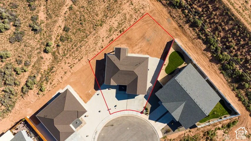 Property featuring a cul-de-sac location, paved driveway, and sloped roofline