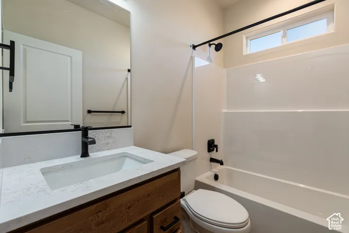 Vanity with an integrated rectangular sink, stone-finish countertop, and wood-finish cabinetry