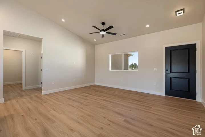 Vaulted ceiling with recessed lighting, wood-finish flooring, and a contemporary ceiling fan
