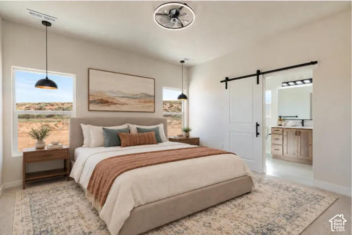 Vaulted ceiling with a contemporary ceiling fan, modern pendant lighting, barn door entry, and wood-finish vanity with a rectangular sink