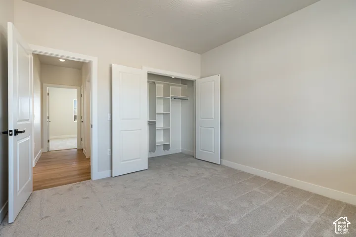Neutral-toned walls complement the light-colored carpeting
