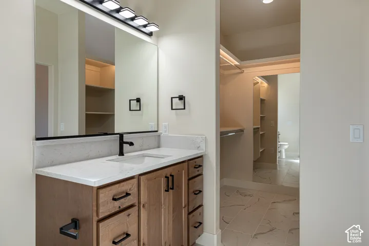 Double vanity with wood-finish cabinetry and light-toned countertops