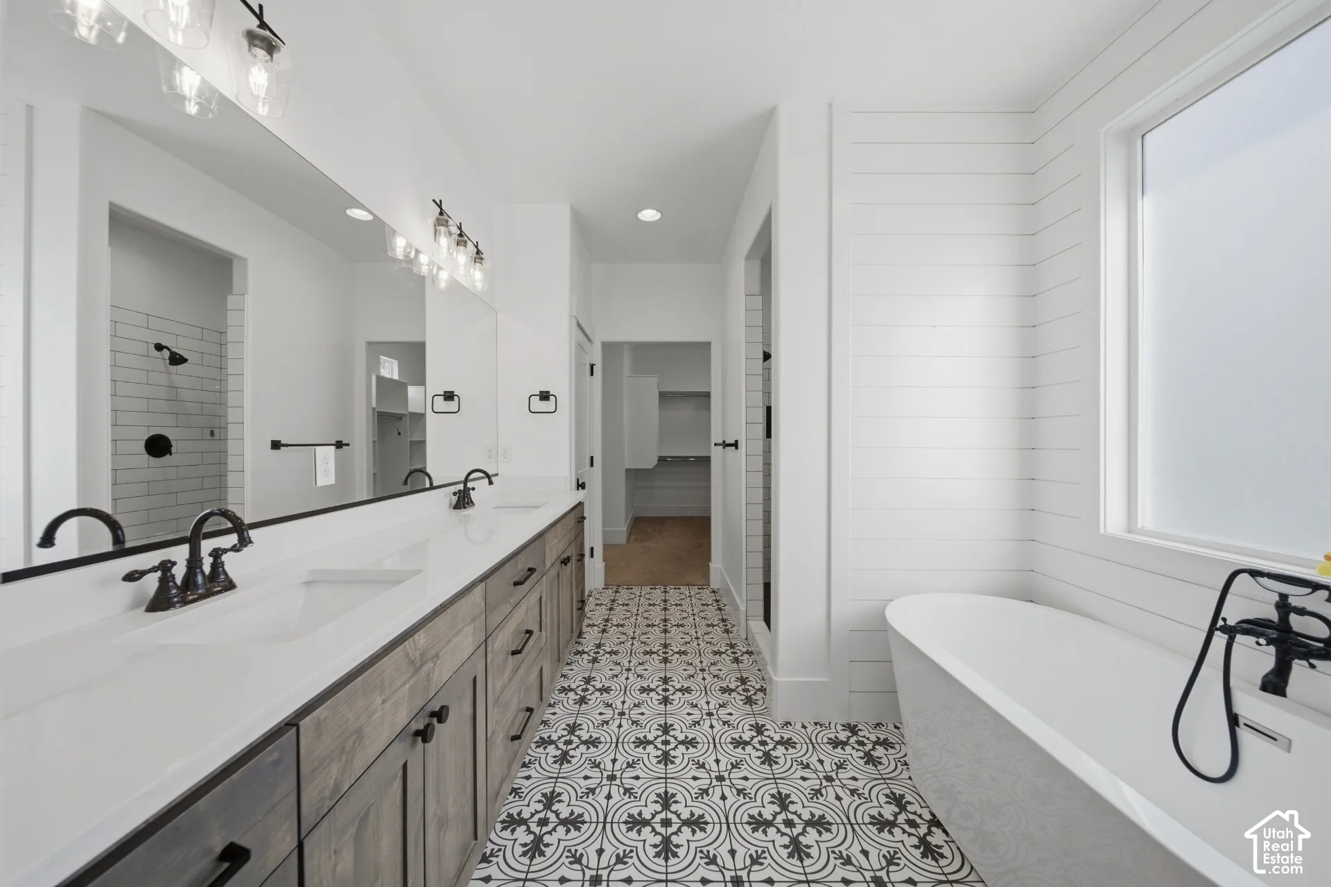 Dual vanity with undermount sinks and dark wood-finish cabinetry