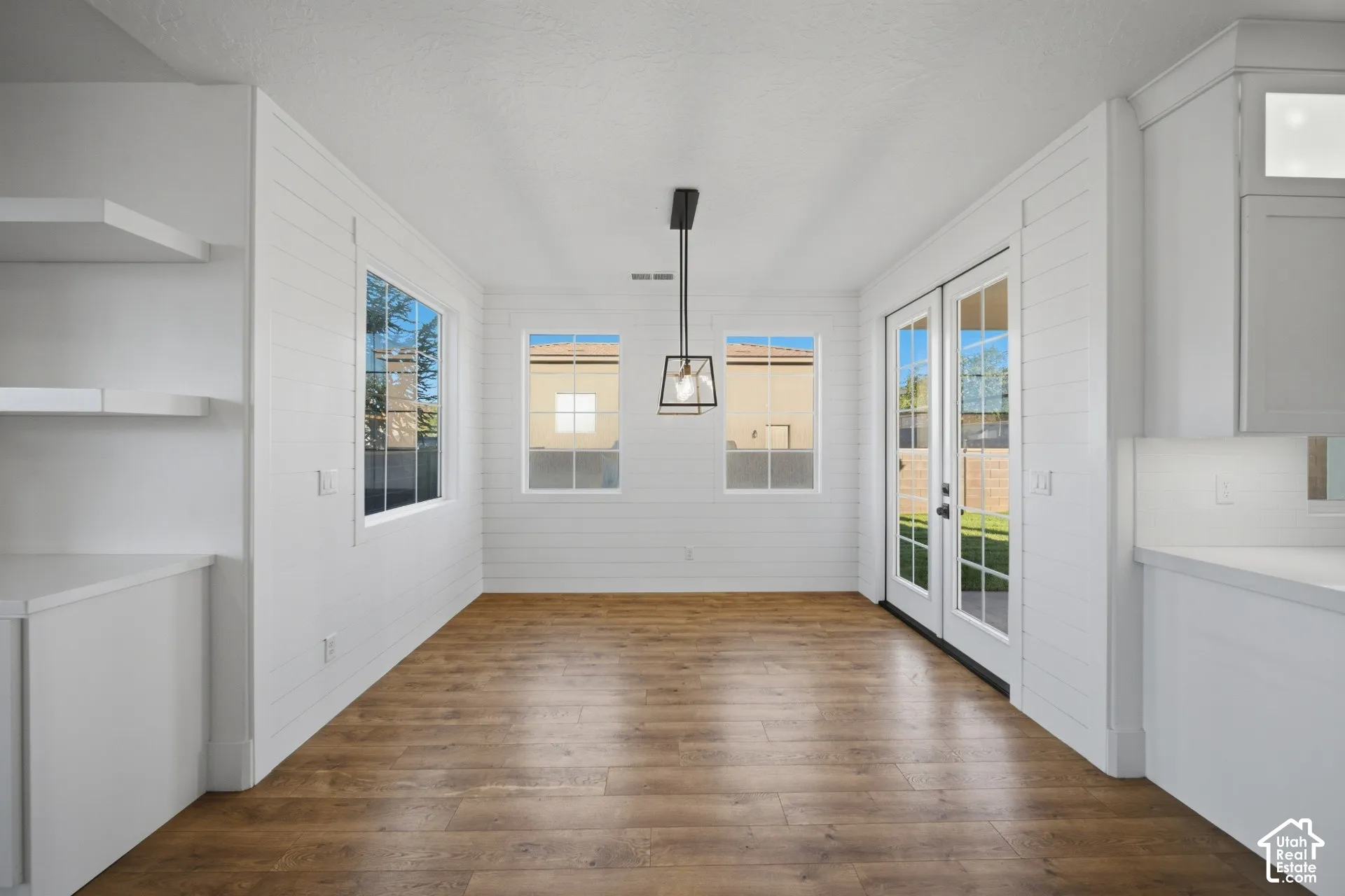 Wood-finish flooring complemented by white shiplap walls