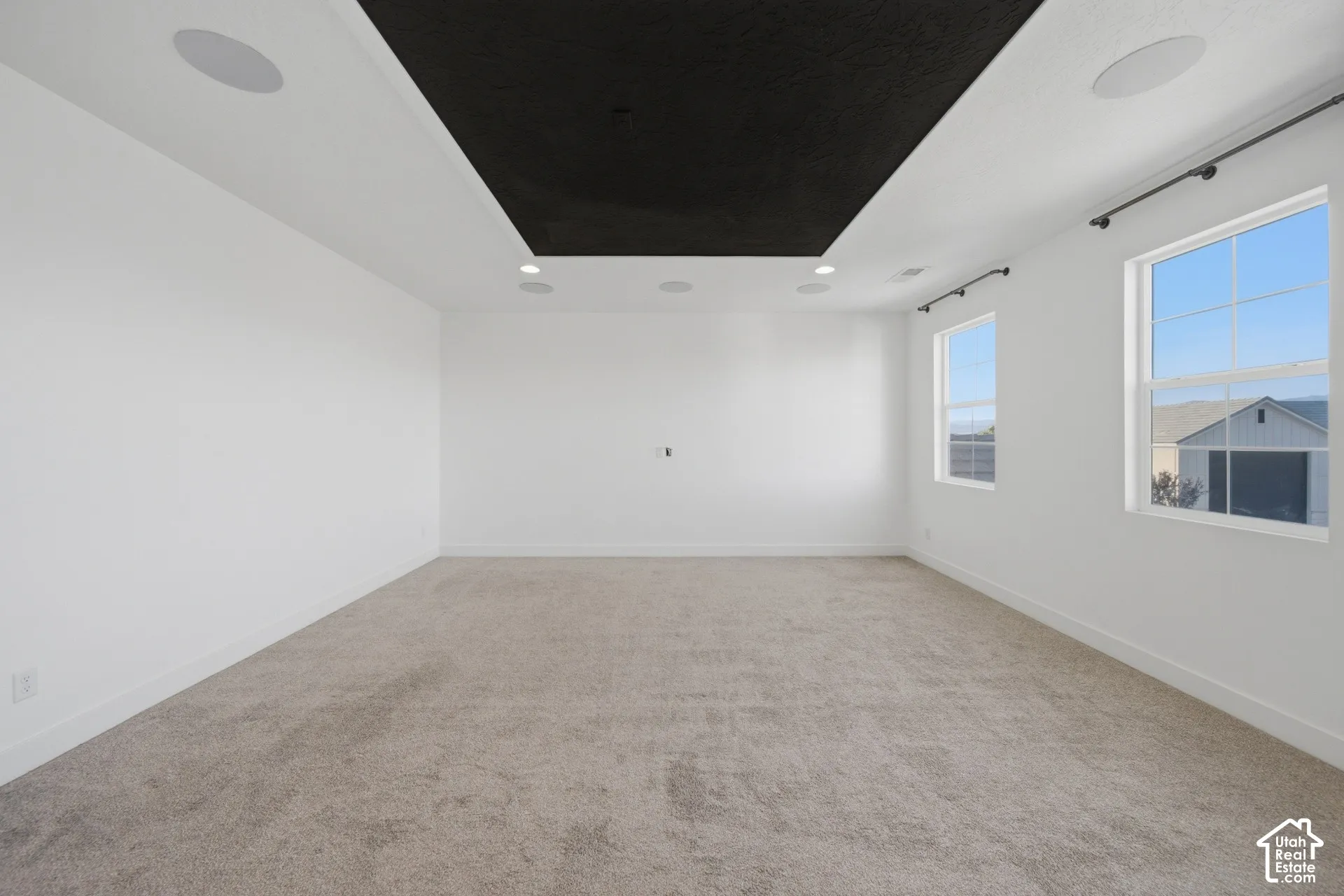 Recessed lighting, integrated ceiling speakers, dual pane windows, and light gray carpeting