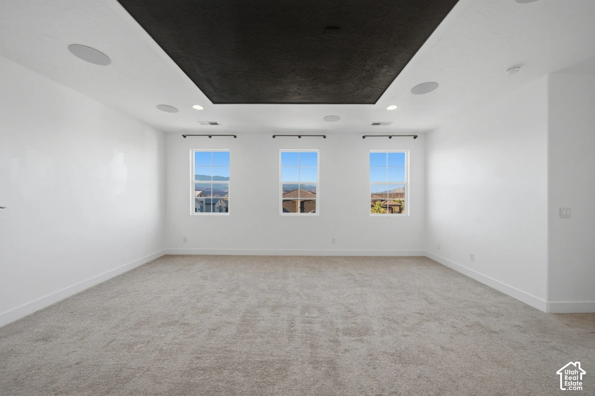 Recessed lighting, integrated ceiling speakers, and carpet flooring