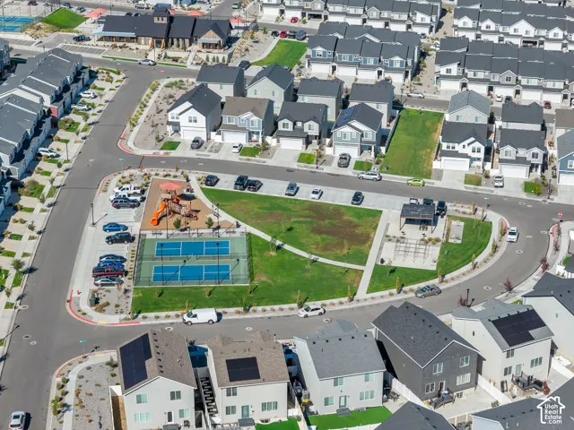Community amenities featuring a playground, two sports courts, and a covered pavilion with seating