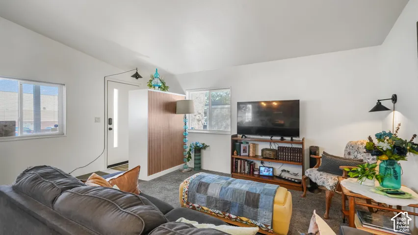 White walls with a textured ceiling, a built-in wall sconce, and recessed lighting