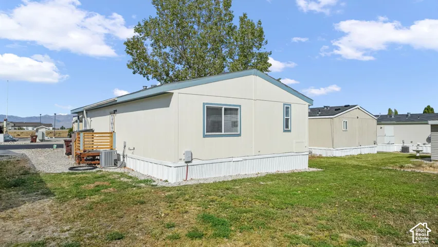 Spacious manufactured home featuring a modern exterior with clean lines, large picture window, and covered entry