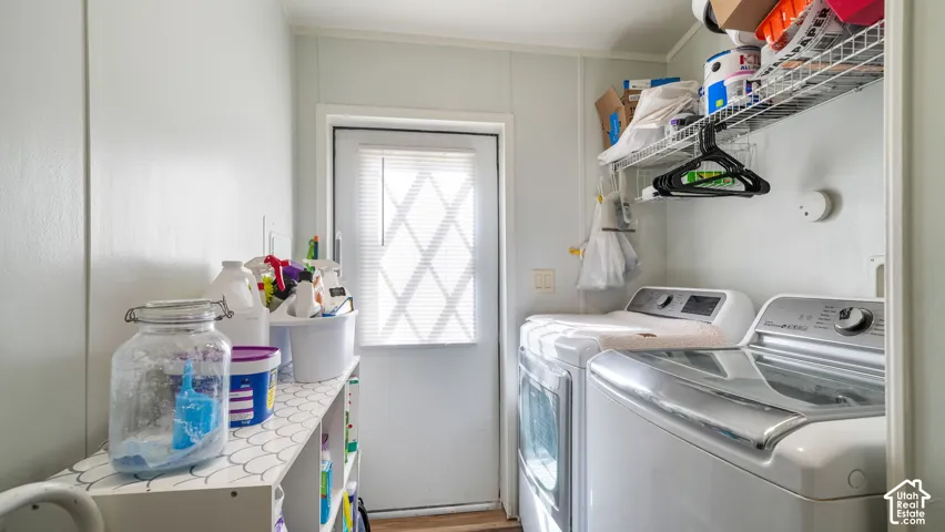 Laundry area with a white door featuring a diamond-patterned window insert