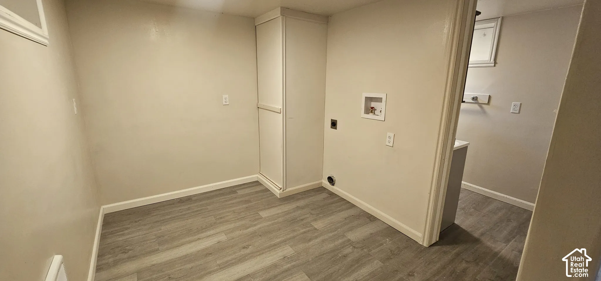 Wood-finish flooring, built-in storage cabinet, and laundry hookups