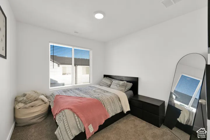 White walls with a single window featuring horizontal blinds